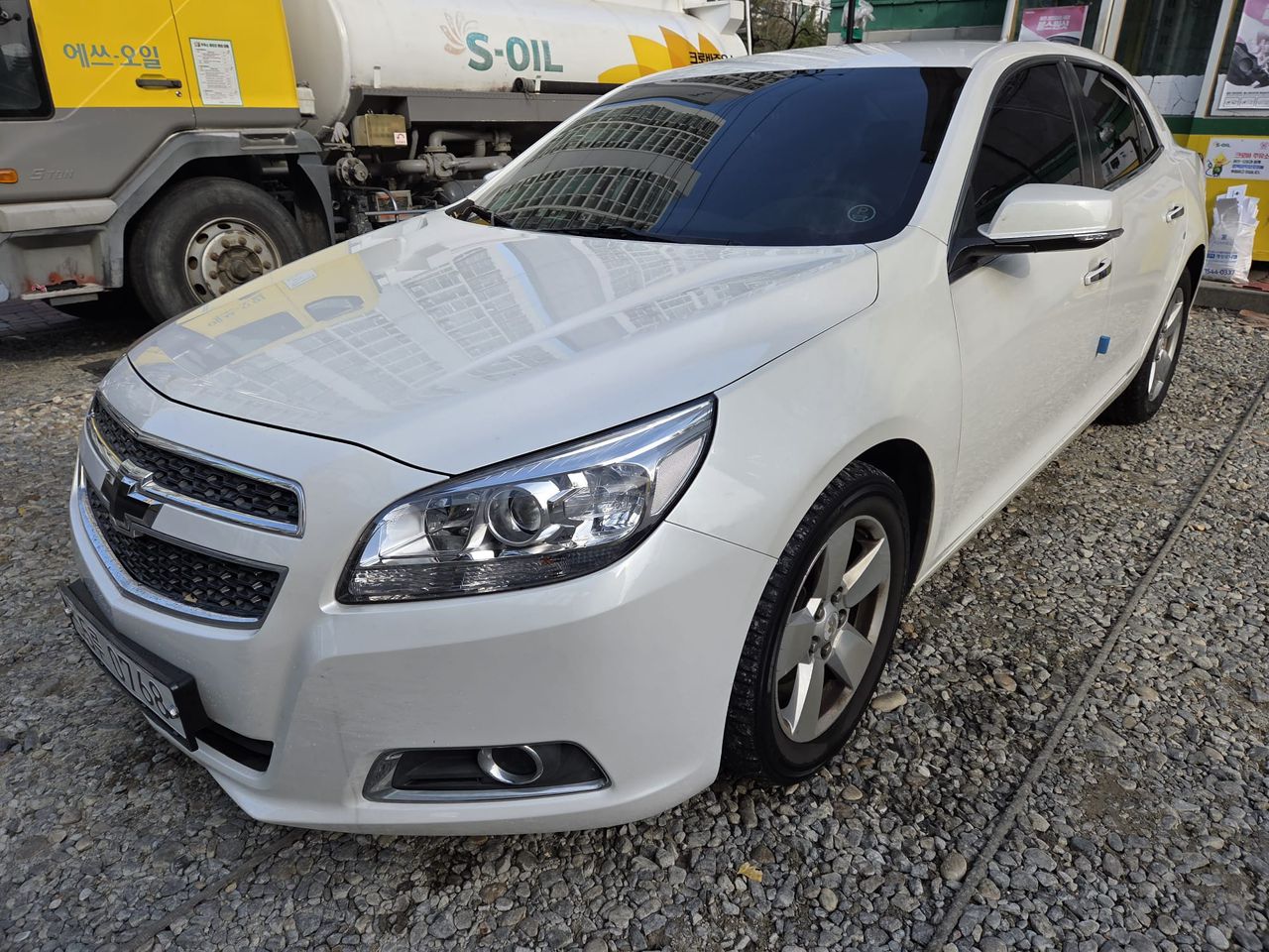 Chevrolet Malibu LTZ front three quarter view in white